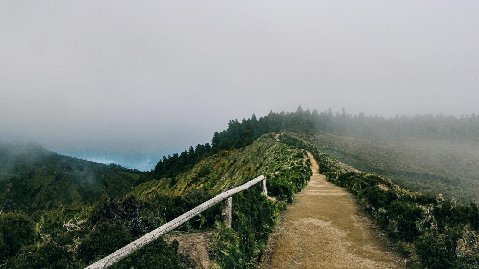 A foggy mountain pathway in the Azores, Portugal, offering a serene outdoor scenic view.