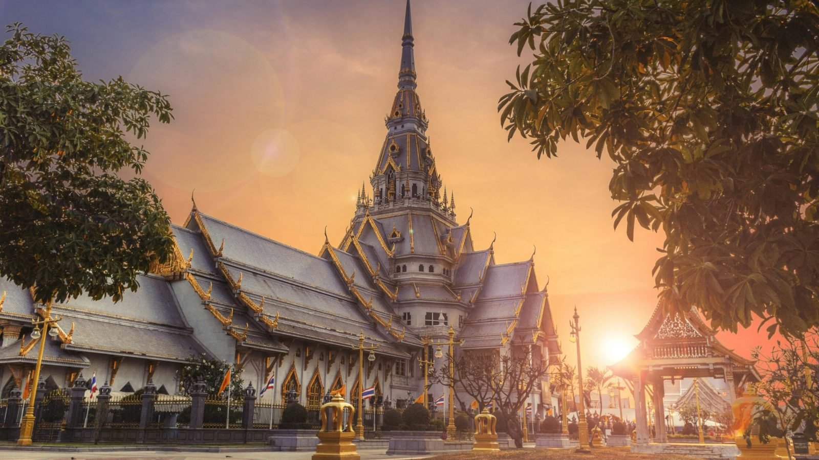 Scenic view of Wat Sothonwararam Temple during sunset in Thailand, capturing its beautiful architecture.